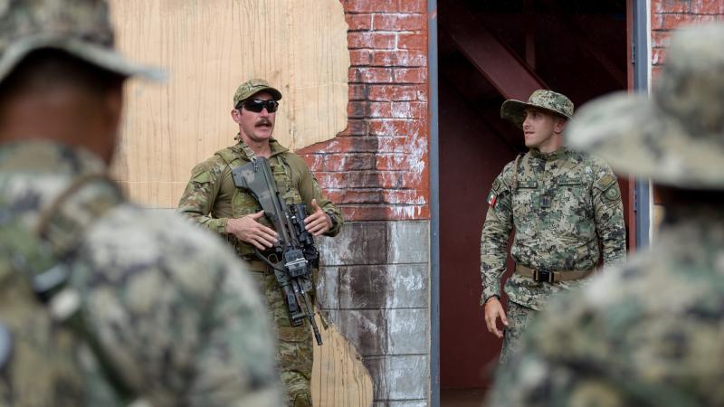 Australian Army soldier Private Lucas Hinselwood briefs marines from the Mexican Naval Infantry during urban close combat training on Exercise Rim of the Pacific (RIMPAC) 2022. Photo: Corporal John Solomon