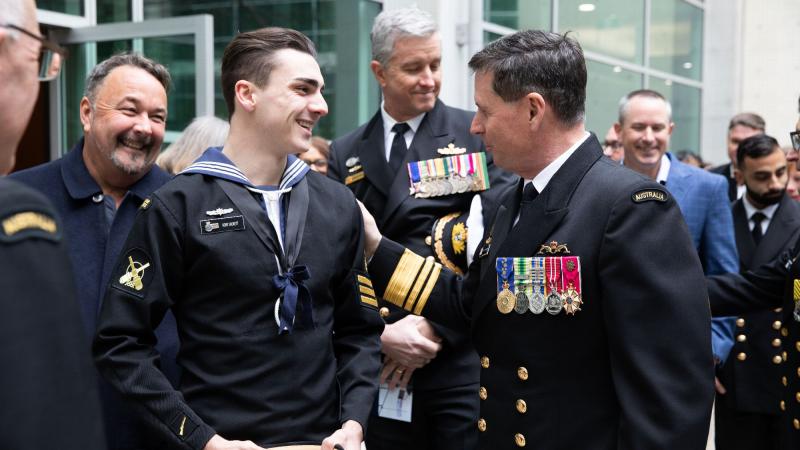 Navy Cadet Chief Petty Officer Rory Jacket, left, congratulates Vice Admiral Mark Hammond after the Chief of Navy Change of Command Ceremony at Russell Offices, Canberra.