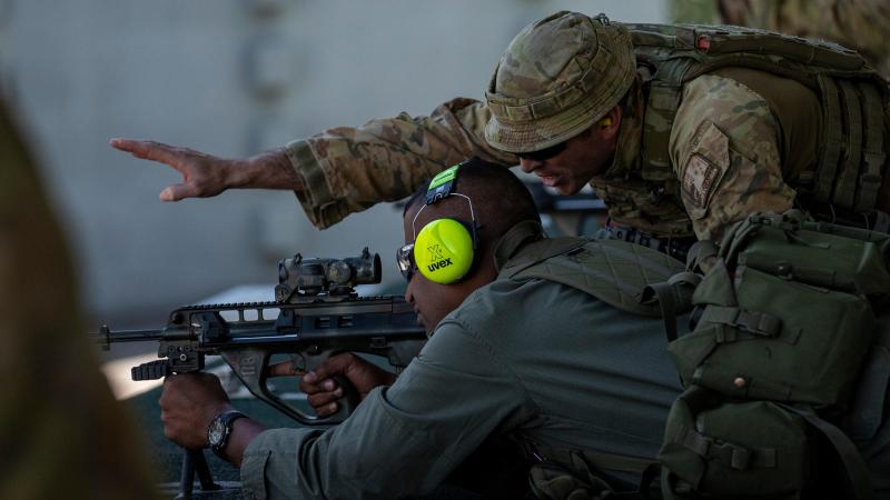 Australian Army rifleman Corporal Joshua Townsend coaches a soldier from the Republic of Fiji Military Forces during a live-fire qualifying shoot at Gallipoli Barracks. Photo: Corporal Nicole Dorrett