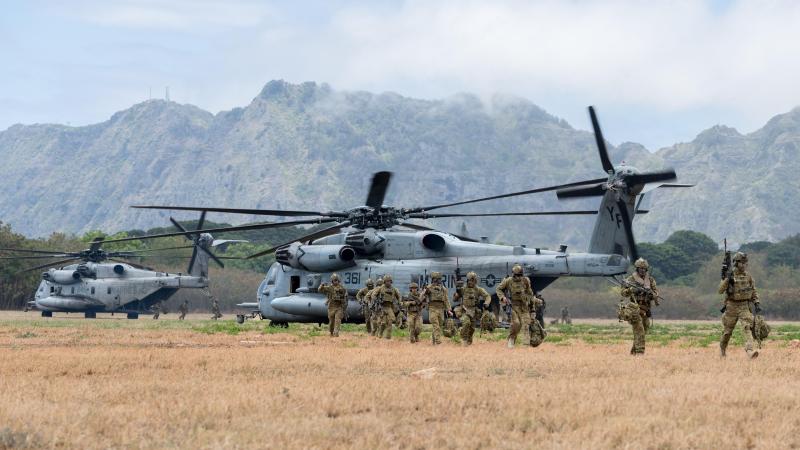 Australian Army soldiers from 1st Battalion, Royal Australian Regiment, disembark from two US Marine Corps CH-53 Sea Stallions during a simulated urban close combat scenario on Exercise Rim of the Pacific (RIMPAC) 2022. Photo: Corporal John Solomon