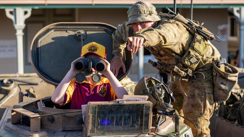 A soldier from 3rd Battalion, Royal Australian Regiment interacts with a Charters Towers local at the at the Exercise Brolga Run 2022 community open day. Photo: Gunner Gregory Scott