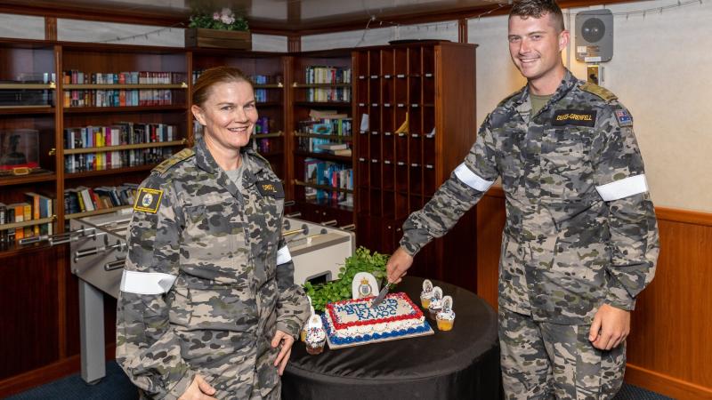 Major Raechel Driscoll and Private Caylun Dukes-Grenfell cut a cake to commemorate the 120th birthday of the Royal Australian Army Ordnance Corps on board HMAS Canberra during Exercise Rim of the Pacific 2022. Photo: Leading Seaman Matthew Lyall