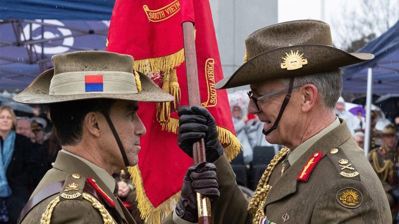 The Army Banner is handed from outgoing Chief of Army Lieutenant General Rick Burr, right, to incoming Chief of Army Lieutenant General Simon Stuart during the Chief of Army handover parade. Photo: Kym Smith