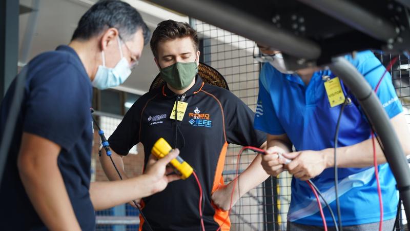 The James Cook University team work on their autonomous vehicle for the RobotX competition in November. Photo: Supplied