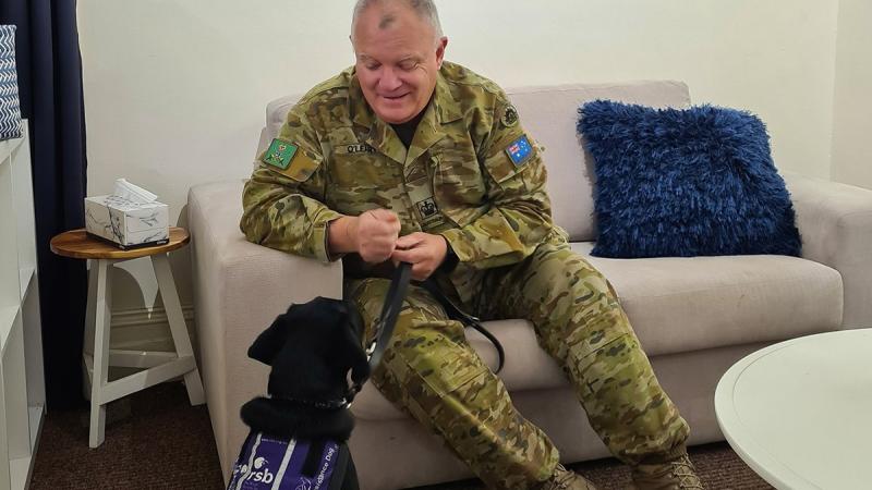 Warrant Officer Class Two Kym O'Leary with Labrador 'York', a Royal Society for the Blind dog in training, at the Keswick Cafe at Keswick Barracks in Adelaide. 