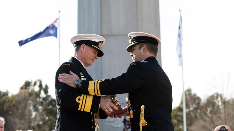 Vice Admiral Michael Noonan presents the "weight" of command to Vice Admiral Mark Hammond during the Chief of Navy Change of Command Ceremony. Photo: Leading Seaman Tara Morrison