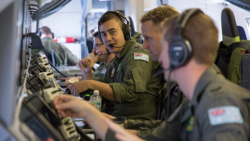 No. 11 Squadron airborne electronic analysts keep constant communications flowing for situational awareness on board the P-8A Poseidon during a mission as part of Operation Resolute. Photo: Corporal Craig Barrett