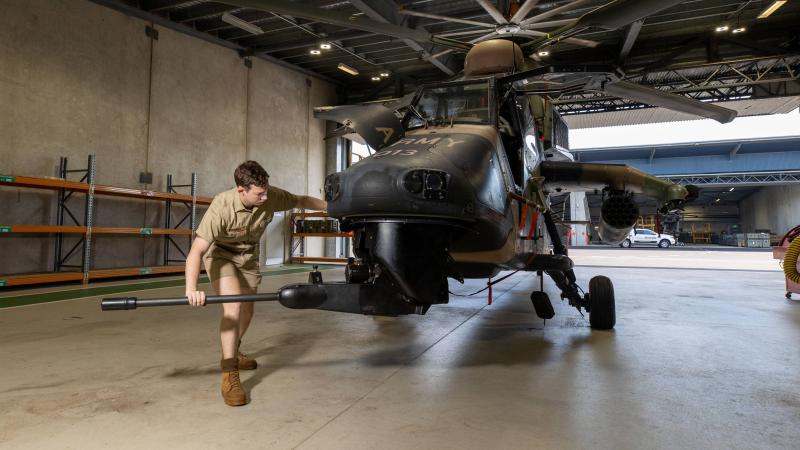 Craftsman Cameron Powell moves the 30mm cannon on a Tiger armed reconnaissance helicopter at Robertson Barracks in Darwin. Photo: Corporal Rodrigo Villablanca