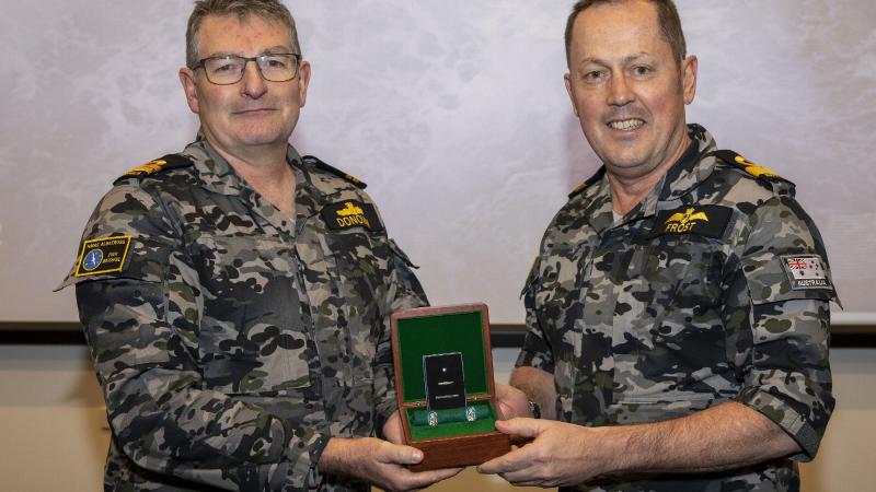 Commander Fleet Air Arm Commodore David Frost, right, presents Lieutenant Ian Donovan with the Federation Star for 40 years of service at a presentation ceremony at HMAS Albatross. Photo: Petty Officer Justin Brown