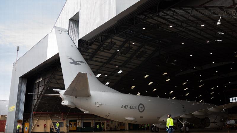 A Royal Australian Air Force P-8A Poseidon is marshalled out of the No. 11 Squadron maintenance hangar by ground crew at RAAF Base Edinburgh. Photo: Leading Aircraftman Sam Price