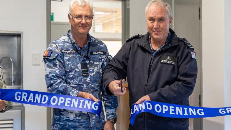 Squadron Leader Paul Summers, left, and Group Captain Anthony Stainton cut the ribbon at the grand opening of the Williamtown Allied Health Services building. Photos: Leading Aircraftman Samuel Miller