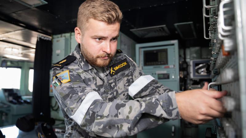 Able Seaman electronics technician Edward Simcock works on the navigation system on the bridge of HMAS Warramunga while on deployment. Photo: Leading Seaman Daniel Goodman