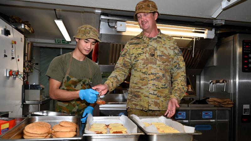 Sergeant Nathan Judd, right, with caterer Private Sam O’Brien in the deployable catering capability during the Army Aboriginal Community Assistance Program in Gapuwiyak, Northern Territory. Photo: Warrant Officer Class Two Kim Allen