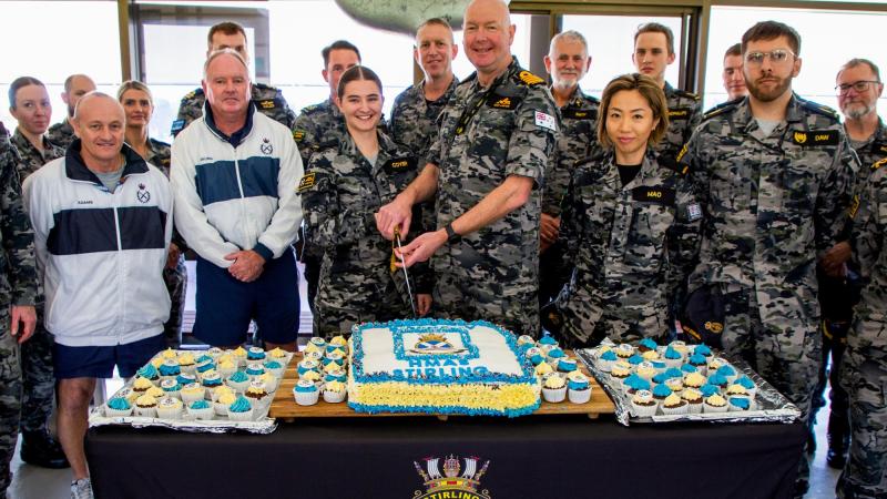 Commanding Officer HMAS Stirling Captain Gary Lawton cuts HMAS Stirling's birthday cake with the bases youngest member Seaman Amity Coyer. Photo: Lieutenant Gary McHugh