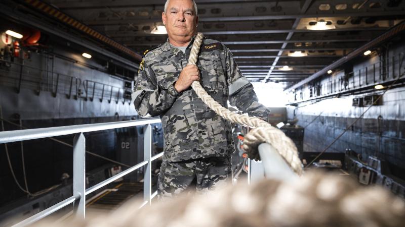 Lieutenant Commander David Gould, First Lieutenant of HMAS Canberra, squares away lines as the ship conducts Exercise Rim of the Pacific (RIMPAC) 2022 in the Pacific Ocean. Photo: Leading Seaman Matthew Lyall