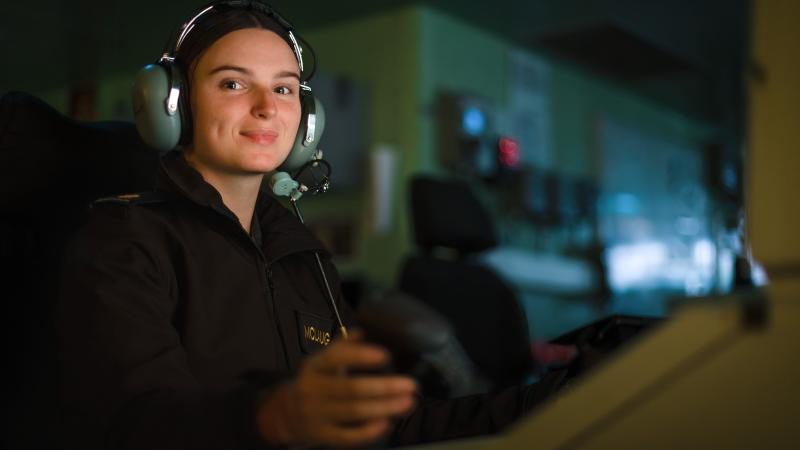 Able Seaman Miranda McLaughlin operates the combat system consoles in the operations room of HMAS Canberra during Exercise Rim of the Pacific (RIMPAC) 2022. Photo: Leading Seaman Matthew Lyall