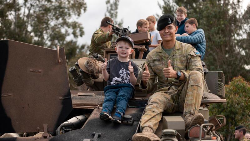 Australian Army troopers from the 2nd/14th Light Horse Regiment interact with members of the community during a heavy vehicle capability display as part the Gallipoli Barracks Open Day 2022, Brisbane. Photo: Corporal Nicole Dorrett