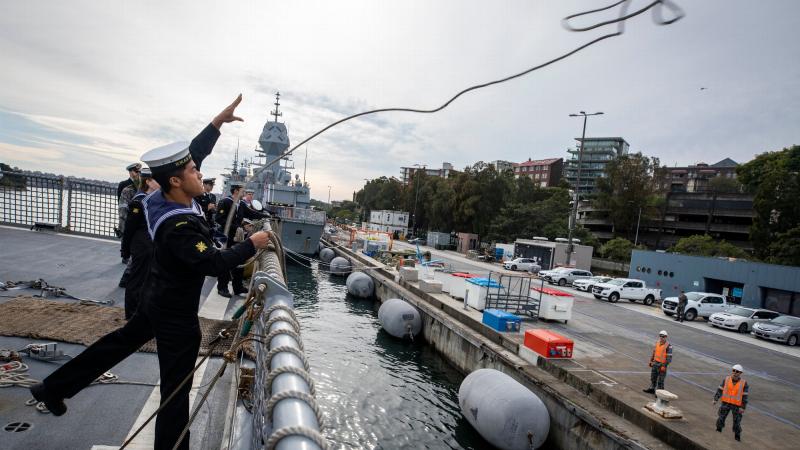 Combat Systems Operator Able Seaman Tony Luu throws a heaving line from HMAS Parramatta as the ship prepares to berth at Fleet Base East on return from a regional presence deployment. Photo: Leading Seaman Leo Baumgartner