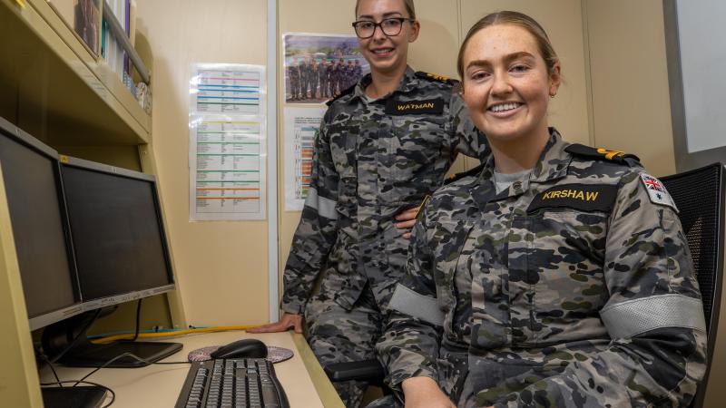 Maritime human resources officers Lieutenant Commander Laura Watman, left, and Sub-Lieutenant Katelyn Kirshaw together in the personnel office on board HMAS Canberra. Photo: Petty Officer Christopher Szumlanski