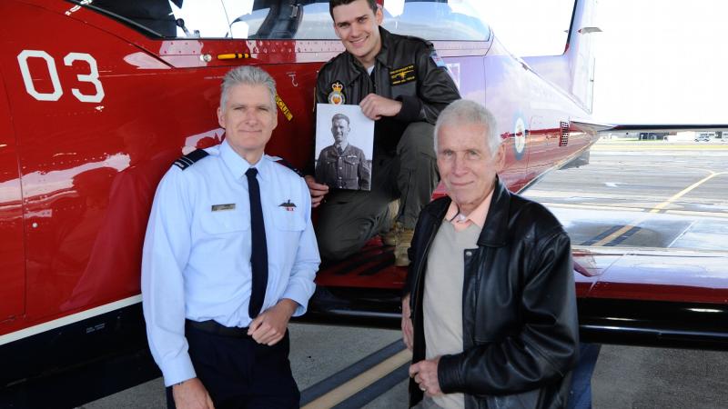 Pilot Officer Mitchell Kennedy, centre, with his father, grandfather and photo of his great-grandfather next to a PC-21 aircraft at RAAF Base Pearce. Photo: Chris Kershaw