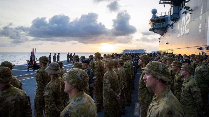 HMAS Canberra’s (III) ship’s company parade on the flight deck during a commemorative service for 80th anniversary of the Battle of Savo Island. Photos: Leading Seaman Matthew Lyall