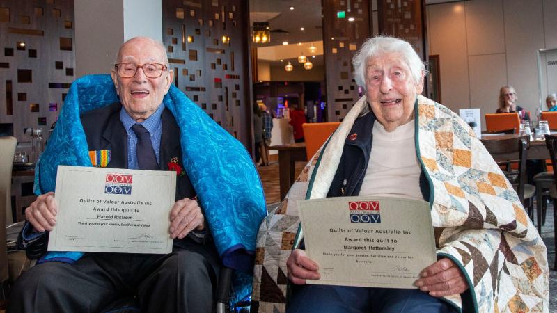 WW2 veterans Harold “Hiram” Ristrom and Margaret Hattersley receive handmade quilts from the Quilts of Valour Foundation during a lunch held at the Bentleigh RSL, Victoria. Photo: Leading Seaman James McDougall