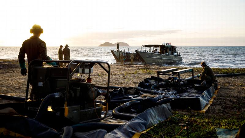 Petroleum Operators from the 17th Sustainment Brigade pump fuel from an LCM8 to land Cowley Beach Training Area in Queensland. Photo: Captain Thomas Kaye