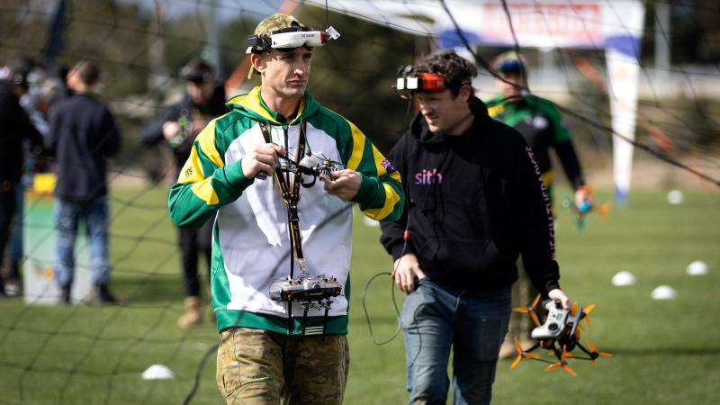 Australian Army soldier Lance Bombardier Riley Van Leeuwen from the 131st Surveillance and Target Acquisition Battery returns from retrieving his racing drone from the track during the Drone Racing National Championships. Photo: Sergeant Matthew Bickerton