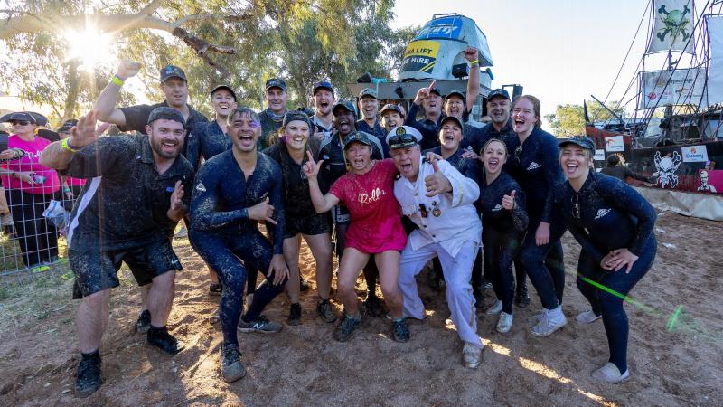 Leanne Caban (centre) with the captain, Stephen Smith, and crew of HMAS Courage after participating in the Battle of the Boats at the Henley on Todd Regatta in Alice Springs. Photo: Leading Seaman Shane Cameron