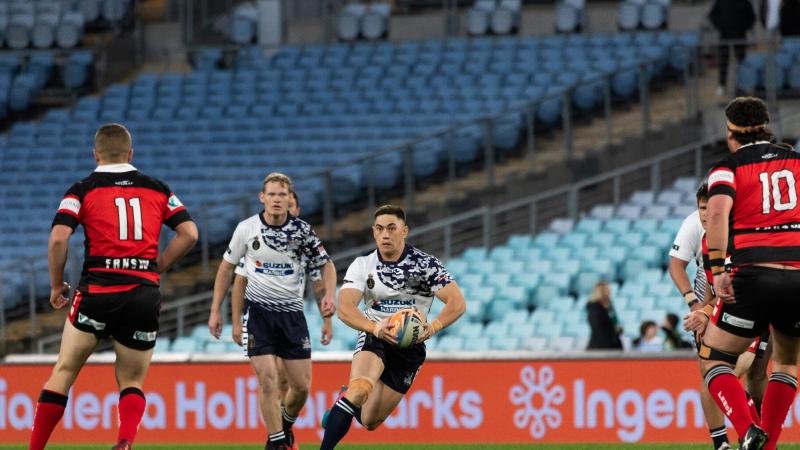 Able Seaman Manuel Grundy-Quay runs the ball as the Navy Tridents play Fire and Rescue NSW in the Community Cup Rugby League game at Accor Stadium in Sydney. Photo: Leading Seaman Daniel Goodman