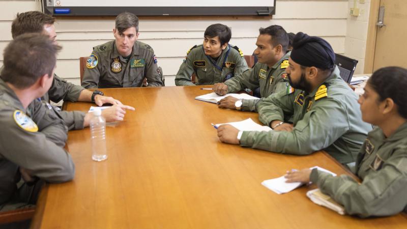 Members of the Royal Australian Air Force and Indian Navy P-8 flight teams chat during a combined crew training discussion at Joint Base Pearl Harbor-Hickam during Exercise Rim of the Pacific (RIMPAC) 2022. Photo: Leading Seaman Kylie Jagiello