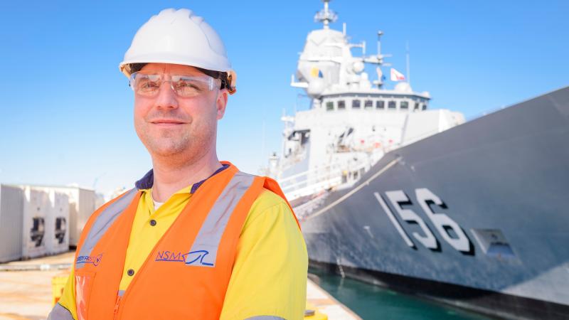 Phil Clifford from the Defence Industry Pathways Program stands in front of HMAS Toowoomba, the seventh Anzac-class frigate of the Royal Australian Navy. Photo: Simon Casson