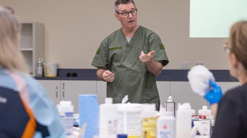 Major Paul Krohn teaching clinicians how to make silicone wound prosthetics.