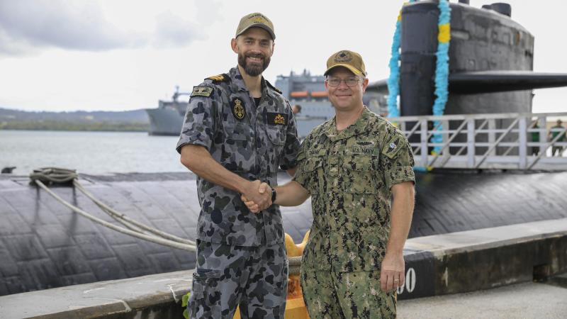 Navy submariner Lieutenant Commander Daniel McCall, left, and US Navy Submarine Squadron 15 Commanding Officer Captain Bret Grabbe stand in front of USS Key West, alongside US Naval Base Guam. Photo: Mass Communication Specialist 3rd Class Naomi Johnson