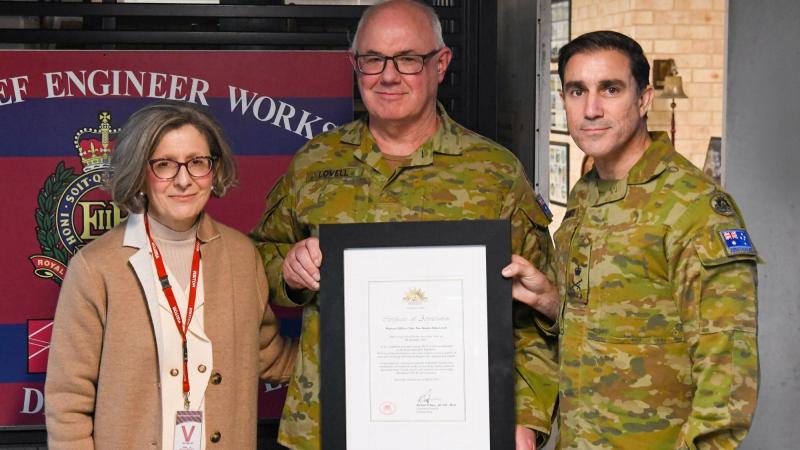 WO2 Simon Lovell, centre, is presented with a Federation Star for 40 years of service by Chief of Army Lieutenant General Simon Stuart at Randwick Barracks, in the presence of his wife, Teresa Lovell. Photo: Corporal James Davison