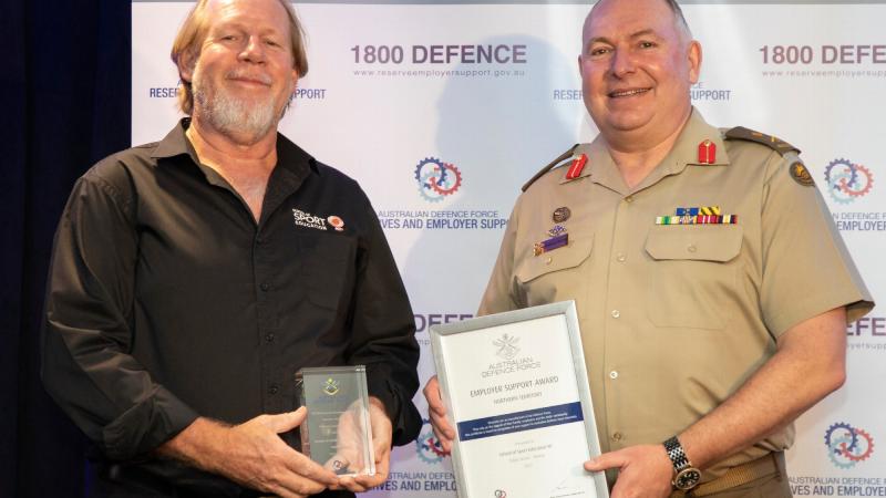 Randall Cook, left, from the School of Sport Education NT, receives his award from Head Joint Support Services Division Major General Douglas Laidlaw at the Employer Support Awards held in Darwin. Photo: Sergeant Pete Gammie