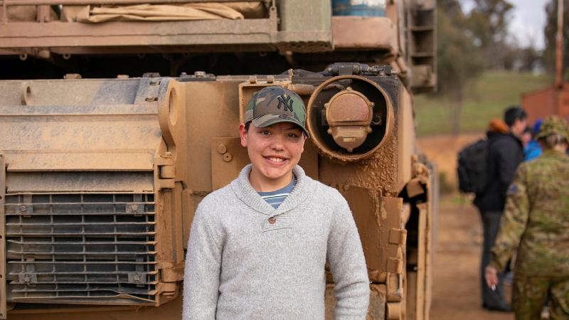 Dash Gurung stands in front of an Australian Army M113 armoured personnel carrier after the firepower demonstration at Puckapunyal. Photo: Lance Corporal Katy Manning 