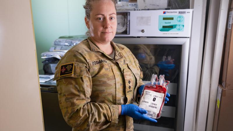Lieutenant Melissa Osmand inspects packed red blood cells stored in a dedicated blood fridge on board HMAS Canberra. Photo: Leading Seaman Matthew Lyall