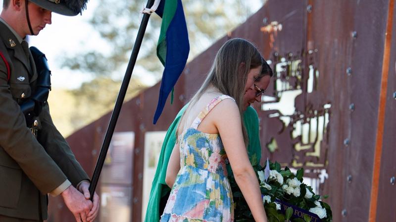 Lance Corporal Rick Milosevic's partner, Kelly Walton, and their daughter lay a wreath at 'Rick's Jump Up' memorial in Quilpie. Photo: Major Roger Brennan