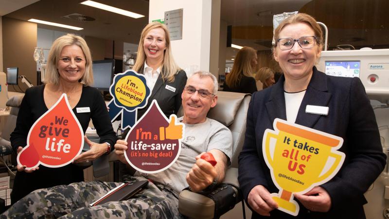 Meg, Sally and Cath from the Red Cross Lifeblood Centre with the Deputy Chief of Navy Rear Admiral Chris Smith as he donates plasma at the launch of the 2022 Defence Blood Challenge. Photo: Petty Officer Bradley Darvill