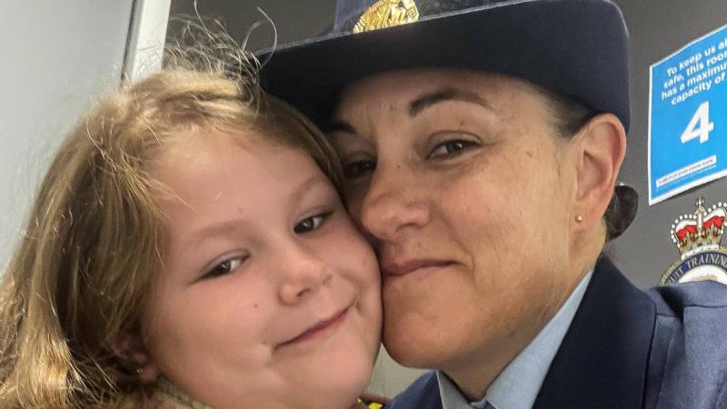 Flight Sergeant Shan Origliasso with her daughter Zahlee, wearing her father’s medals, are supported by Legacy after the loss of their partner and father Leith Walsh in 2019. Photo: Flight Sergeant Shan Origliasso