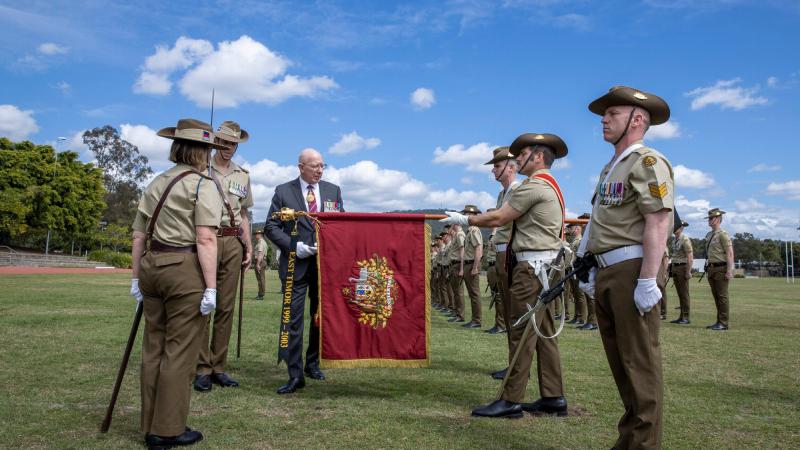 The Governor-General, General (retd) Sir David Hurley, attaches the Streamer, East Timor 1999-2003, to the Princess Anne banner during the 1st Signal Regiment honours parade at Gallipoli Barracks, Brisbane. Photo: Corporal Nicole Dorrett