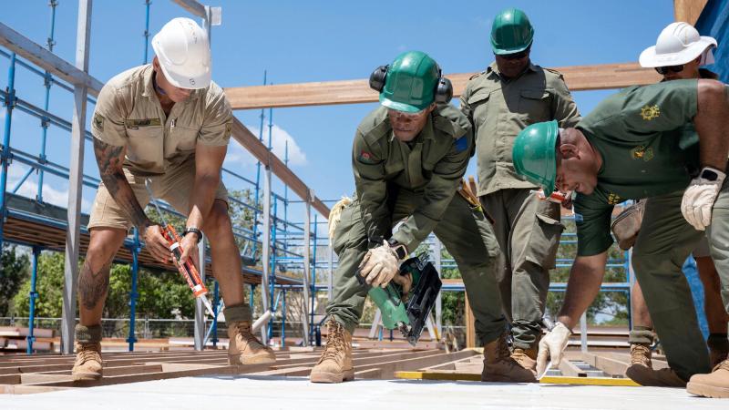 Australian Army soldier Lance Corporal Shane Burley, left, and Republic of Fiji Military Forces soldiers Sapper Eremasi Vasu and Lance Corporal Gasio Waqaitanoa secure floor panelling. Photos: Warrant Officer Class 2 Kim Allen