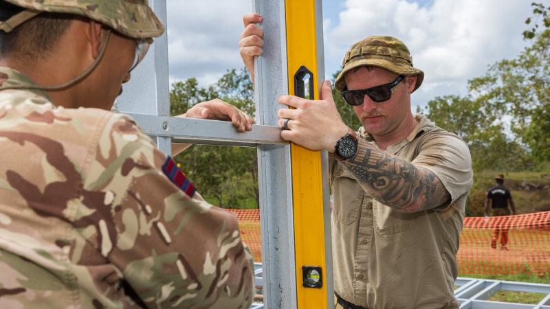 Sapper Cameron Turner, right, from the 6th Engineer Support Regiment, checks the level of a frame on-site during Exercise Puk Puk at Goldie River Training Depot in Papua New Guinea. Photo: Sergeant Nunu Campos