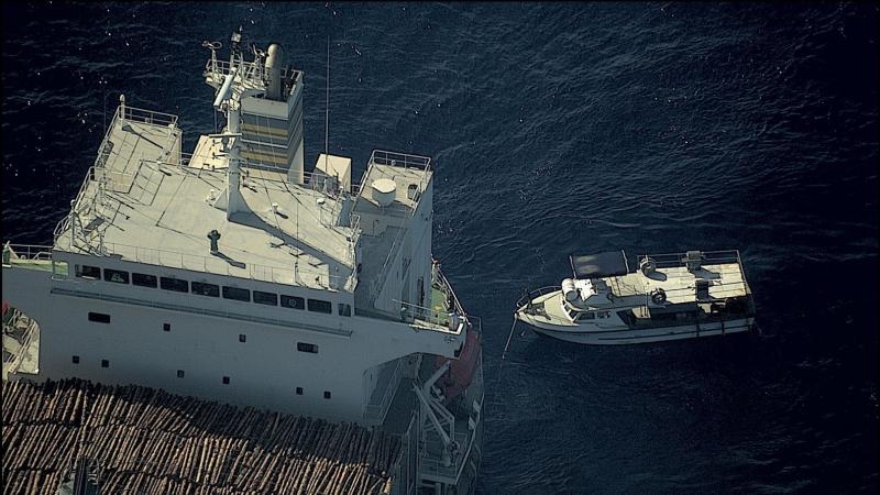 Distressed vessel Ogoi Ratz, left, made ready for towing by civilian merchant vessel Uni Sunshine after being located by RAAF P-8A Poseidon maritime patrol aircraft. Photo: RAAF No. 11 Squadron