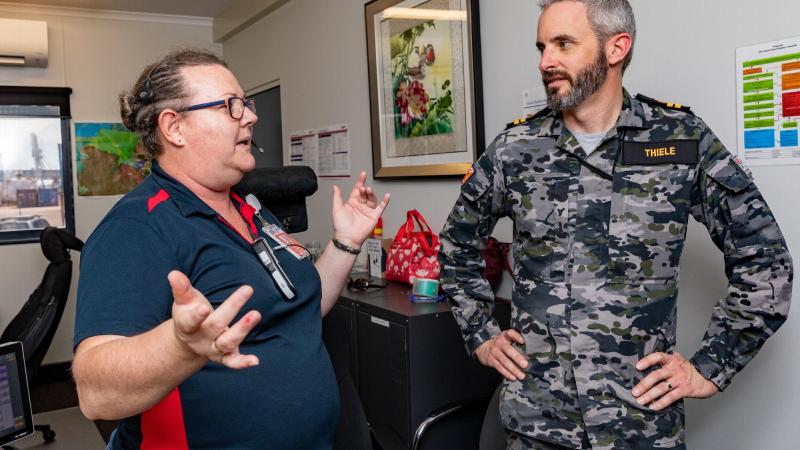 Tracey Small, left, gives Lieutenant Roderick Thiele a tour of the Darwin harbour control office during Exercise Kakadu 2022. Photo: Leading Seaman Shane Cameron