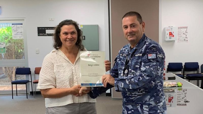 Defence civilian Beryl Webber receives her graduation certificate after successfully completing the Certificate II in Security Operations course at RAAF Base Tindal, Northern Territory.