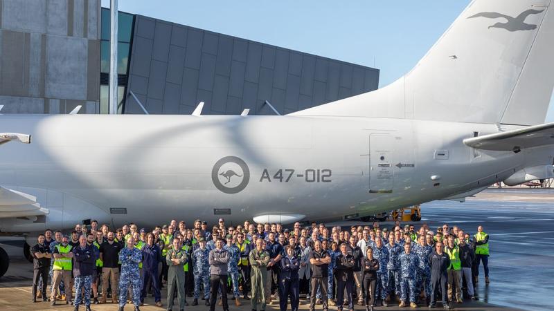 No. 11 Squadron and Airbus maintenance teams celebrate the 100th completed servicing of the P-8A Poseidon platform at RAAF Base Edinburgh, South Australia. Photo: Leading Aircraftman Sam Price