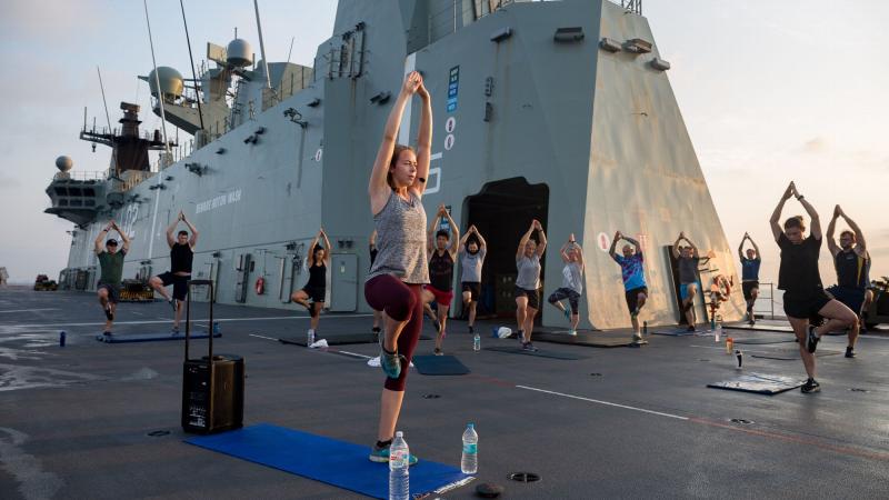 Army Physiotherapist Lieutenant Nicola Hribar leads a sunrise yoga class for members of ship’s company and embarked forces on the flight deck of HMAS Canberra during AUSINDEX 2019. Photo: Leading Seaman Steven Thomson