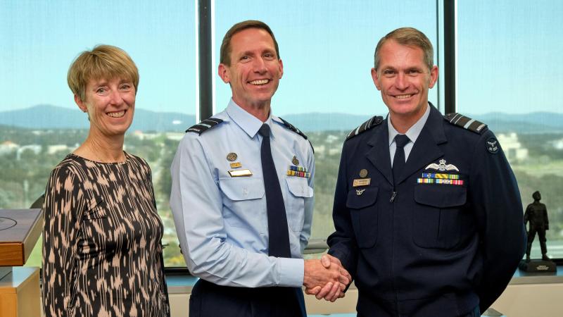 Chief of Air Force Air Marshal Robert Chipman, right, congratulates Air Vice Marshal Steve Edgeley on receiving his Doctor of Philosophy (PhD). Also in attendance was Air Vice Marshal Edgeley's wife, Pippa Edgeley. Photo: Flight Sergeant Kev Berriman